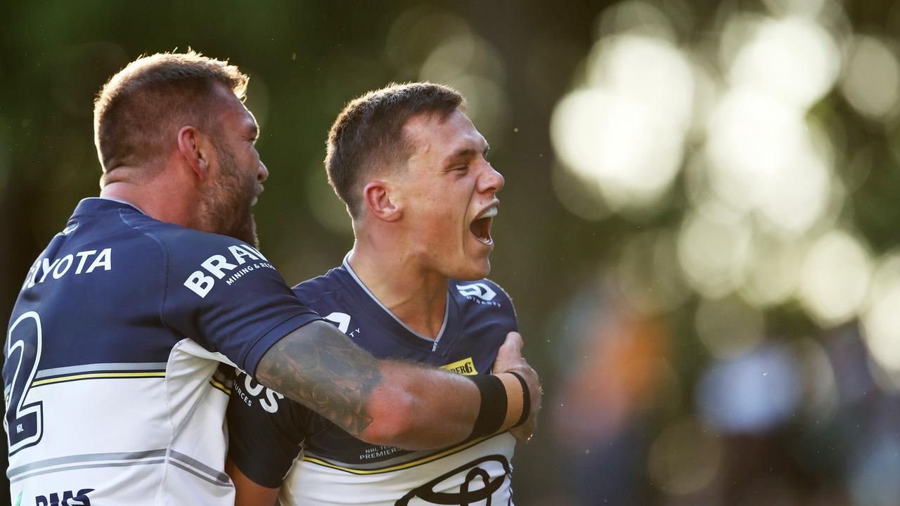 Scott Drinkwater celebrates with teammates after scoring a try