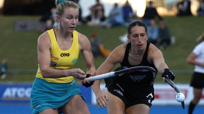 PERTH, AUSTRALIA - JUNE 26: Stephanie Kershaw of the Hockeyroos and Stephanie Dickins of the Black Sticks contest for the ball during the FIH Pro League match between the Australian Hockeyroos and the New Zealand Black Sticks at Perth Hockey Stadium on June 26, 2021 in Perth, Australia. (Photo by Paul Kane/Getty Images)