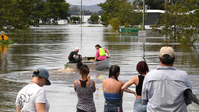 Residents stand by a flooded street in Lawrence suburb, some 70 kilometres New South Wales border city Lismore, on March 1, 2022. Photo: SAEED KHAN / AFP