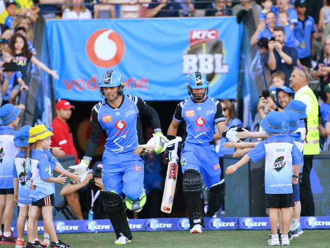 Strikers openers Alex Carey and Jake Weatherald run onto the field during the BBL match against the Sydney Thunder at Adelaide Oval on New Year’s Eve. Photo: David Mariuz/AAP