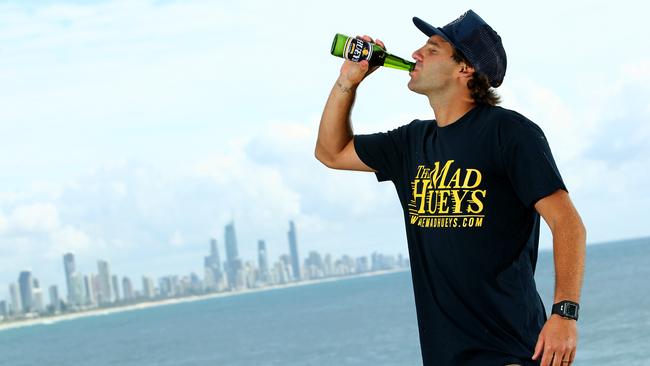 Shaun Harrington on Burleigh Point enjoying a beer that the Mad Hueys have created. Photo: Kit Wise