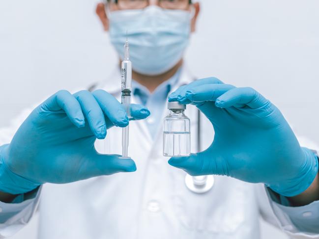 Doctor, nurse, scientist hand in blue gloves holding flu, measles, coronavirus, covid-19 vaccine disease preparing vaccination shot, medicine and drug concept.