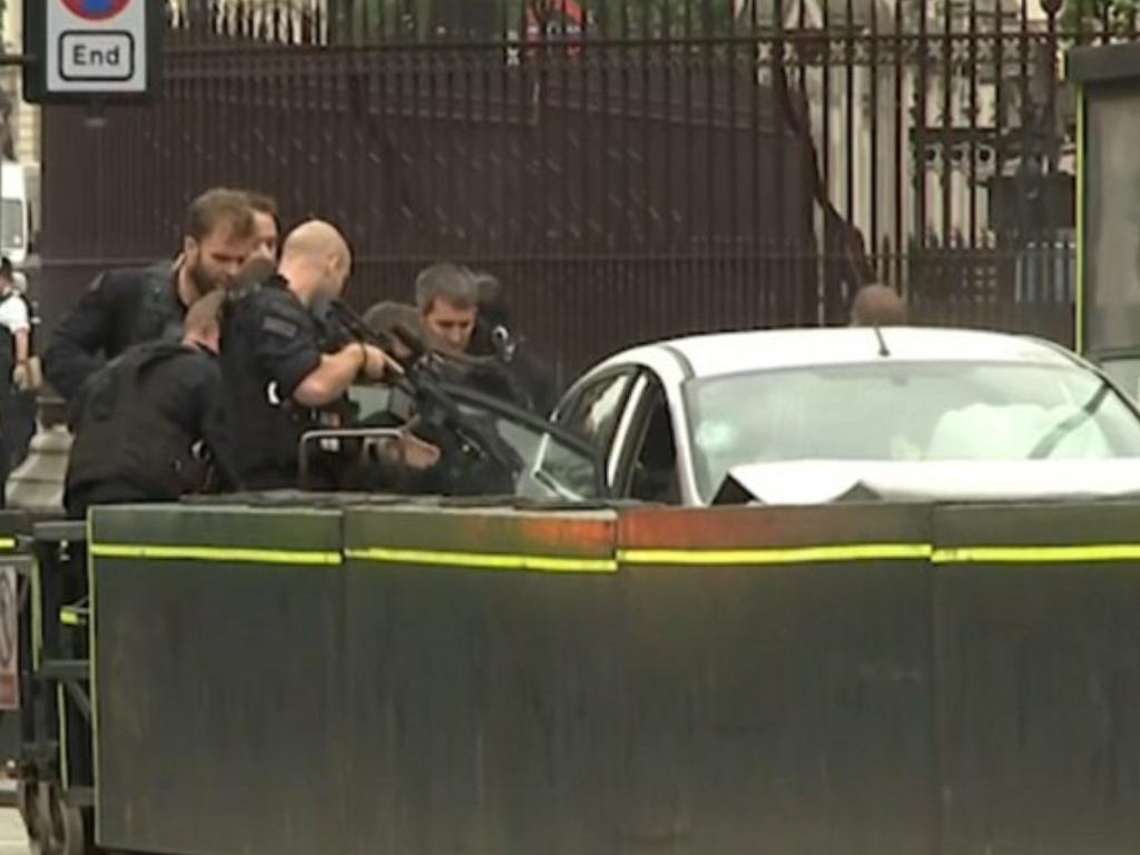 Police surround a silver hatchback after a number of pedestrians were hit. Picture: Sky