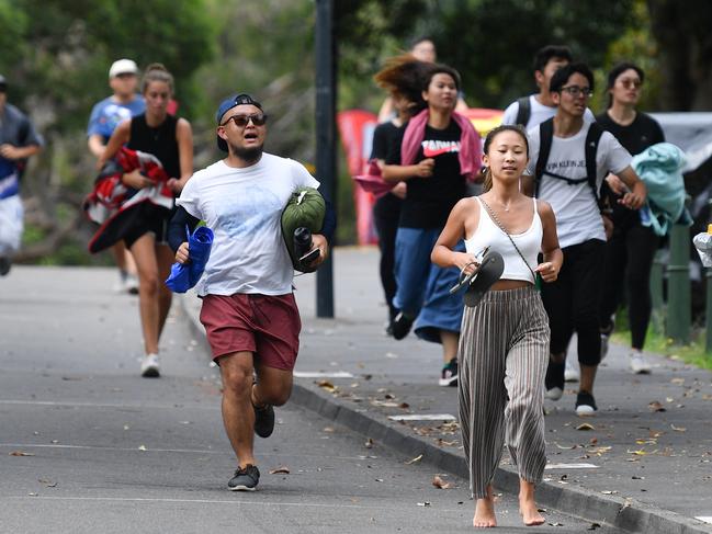 A man is seen running to Mrs Macquarie's Point in preparation for New Years Eve Fireworks in Sydney, Monday, December 31, 2018. Picture: AAP / Brendan Esposito