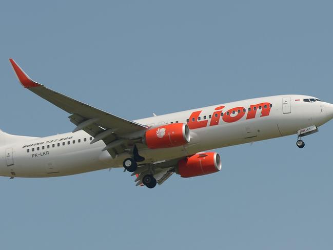 (FILES) This file photo taken on March 18, 2013 shows a Lion Air plane flying over Sukarno-Hatta airport in Tangerang, outside Jakarta. - An Indonesian Lion Air passenger plane went missing on October 29, 2018 shortly after taking off from the capital Jakarta, an aviation authority official said, adding that a search and rescue operation is under way. (Photo by Adek BERRY / AFP)