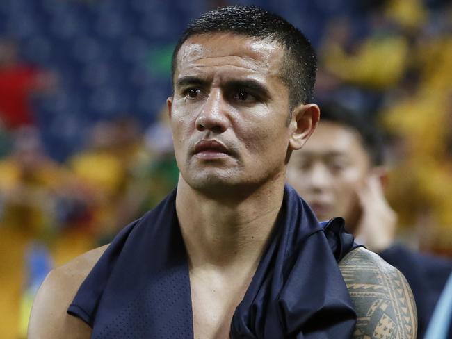 Australia's Tim Cahill looks at Japan's team celebrated their win after their World Cup Group B qualifying soccer match in Saitama, Japan, Thursday, Aug. 31, 2017. (AP Photo/Shuji Kajiayma)