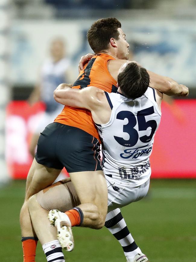 Toby Greene of the Giants hits Patrick Dangerfield of the Cats high in an attempt the fend off a tackle Photo by Darrian Traynor.