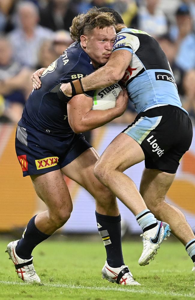 Reuben Cotter of the Cowboys is tackled by Connor Tracey of the Sharks. (Photo by Ian Hitchcock/Getty Images)