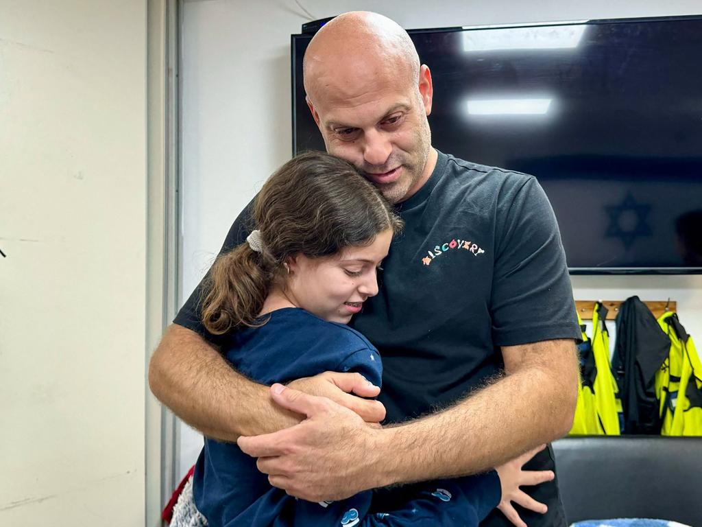 Hila Rotem-Shoshani, 13, embracing her uncle at a hospital in Israel after being released by Hamas. Picture: Israel Army / AFP