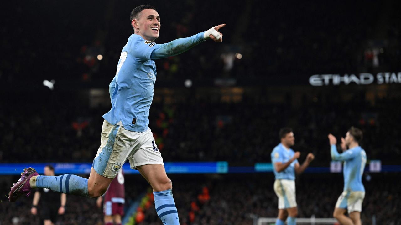 Phil Foden celebrates after scoring. (Photo by Paul ELLIS / AFP)