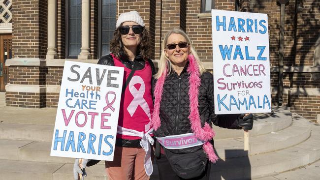 Renee Ridgeley and Deborah De Porre wave signs in support of Kamala Harris because of her promise to continue the Affordable Care Act. Picture: Valaurian Waller