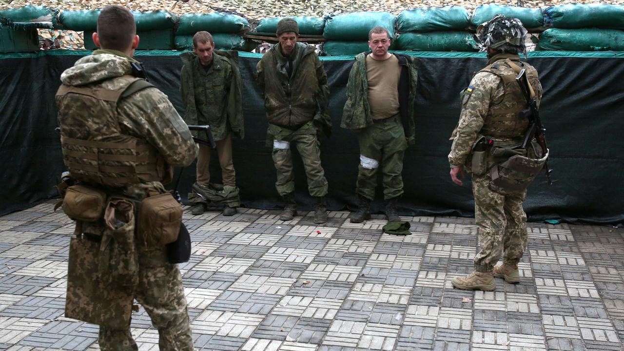 Ukrainian forces detain servicemen of the self-proclaimed Lugansk People's Republic who were captured during the morning attack on the town of Schast'ye, near the eastern Ukraine city of Lugansk, on February 24, 2022. (Photo by Anatolii Stepanov / AFP)