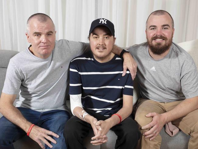 Jack Mcilvar with his father James Mcilvar (L), and brother Brad Mcilvar (R) recovering at home in Hallett Cove, SA. Jack 23 is lucky to be alive after being diagnosed with a severe bone marrow disorder that leaves him completely without red and white blood cells. he needed white cell transfusions form his dad James and his brother Brad to survive. Photographer Emma Brasier