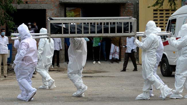 Volunteers from the Social Democratic Party of India carry the abandoned body of a coronavirus victim at a graveyard in Chennai. Picture: AFP