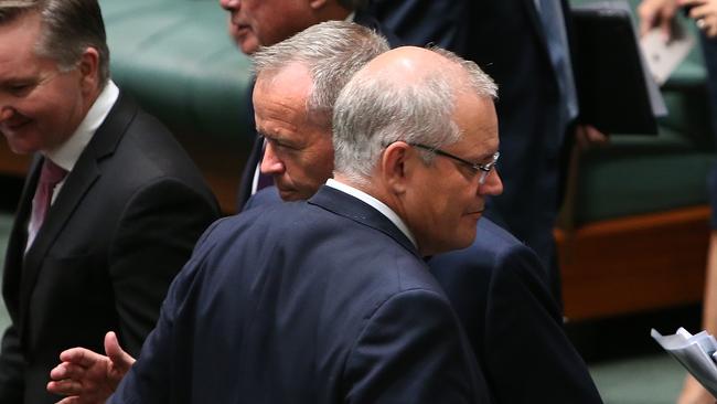 PM Scott Morrison and Opposition Leader Bill Shorten cross paths during a division in the House of Representatives Chamber at Parliament House in Canberra. Picture Kym Smith