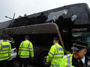 The bus carrying the Manchester United team is escorted by police after having a window smashed on its way to West Ham's Boleyn ground before the English Premier League football match between West Ham United and Manchester United in in east London on May 10, 2016. / AFP PHOTO / GLYN KIRK