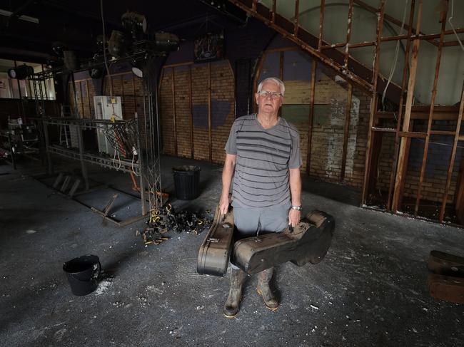Planet Music owner Peter Miller discards destroyed items in Lismore. Picture: Toby Zerna