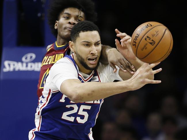 Philadelphia 76ers' Ben Simmons, right, and Cleveland Cavaliers' Kevin Porter Jr. battle for a rebound during the second half of an NBA basketball game, Tuesday, Nov. 12, 2019, in Philadelphia. Philadelphia won 98-97. (AP Photo/Matt Slocum)