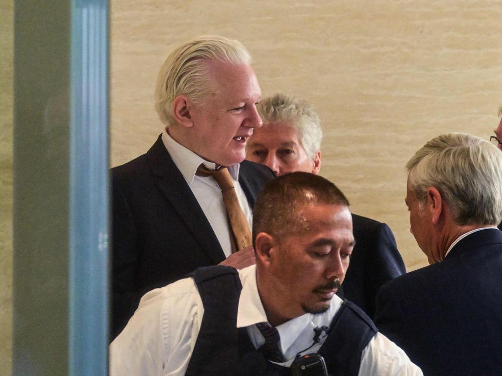 Julian Assange walks through the security area upon his arrival at the US Federal Courthouse. Picture: AFP