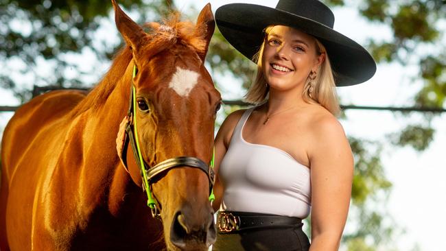 Hannah McCourt gives Stroke of Magic a stroke of love before the Darwin Cup Ladies Day. Picture: Che Chorley