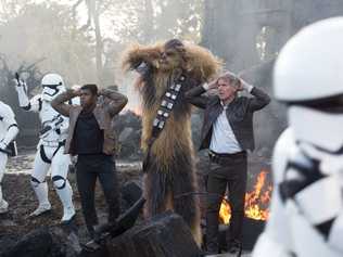 FOR REVIEW AND PREVIEW PURPOSES ONLY. John Boyega, Peter Mayhew (as Chewbacca) and Harrison Ford in a scene from the movie Star Wars: The Force Awakens. Supplied by Disney. Please credit photo to David James. Picture: David James