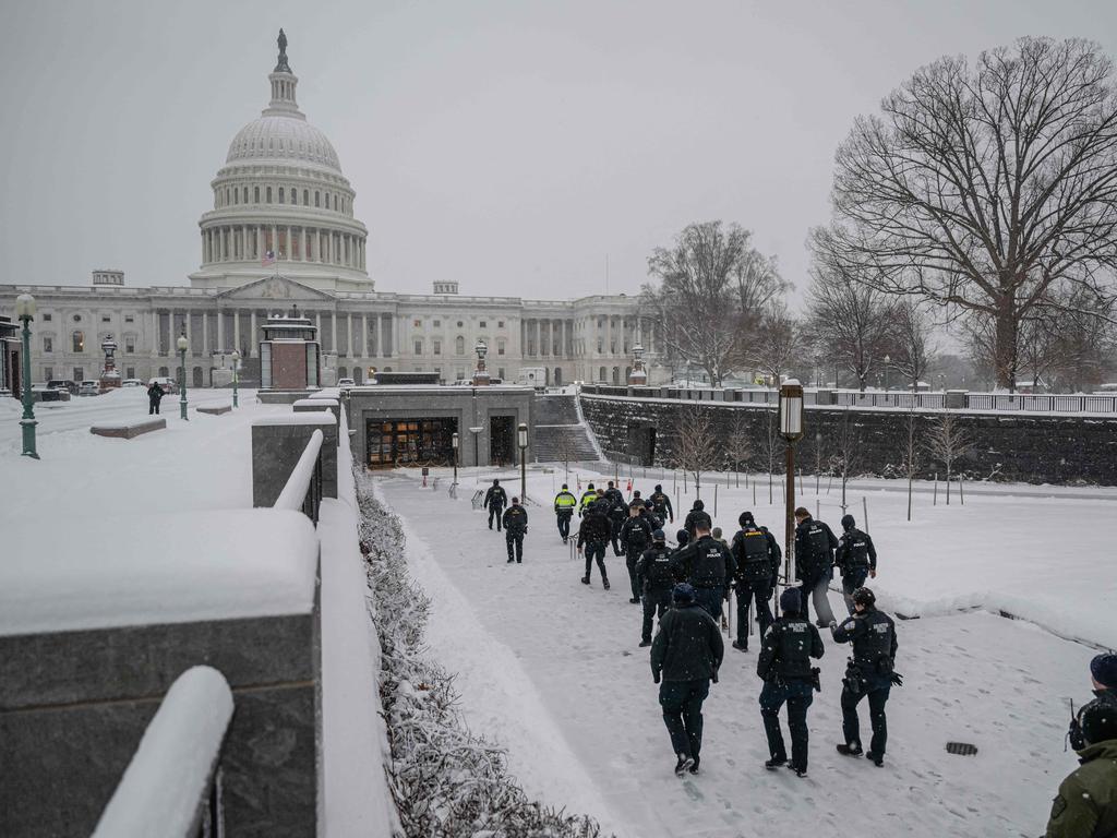 Members of law enforcement walk toward the visitor's centre entrance at the US Capitol during a snowstorm on January 6, 2025 in Washington, DC. Picture: Getty Images via AFP