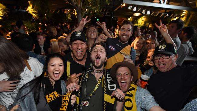 Tigers supporter Fraser Cameron showing off his fake Dusty neck tattoo at the Corner after Richmond’s Grand Final victory in 2017. Picture: Tony Gough