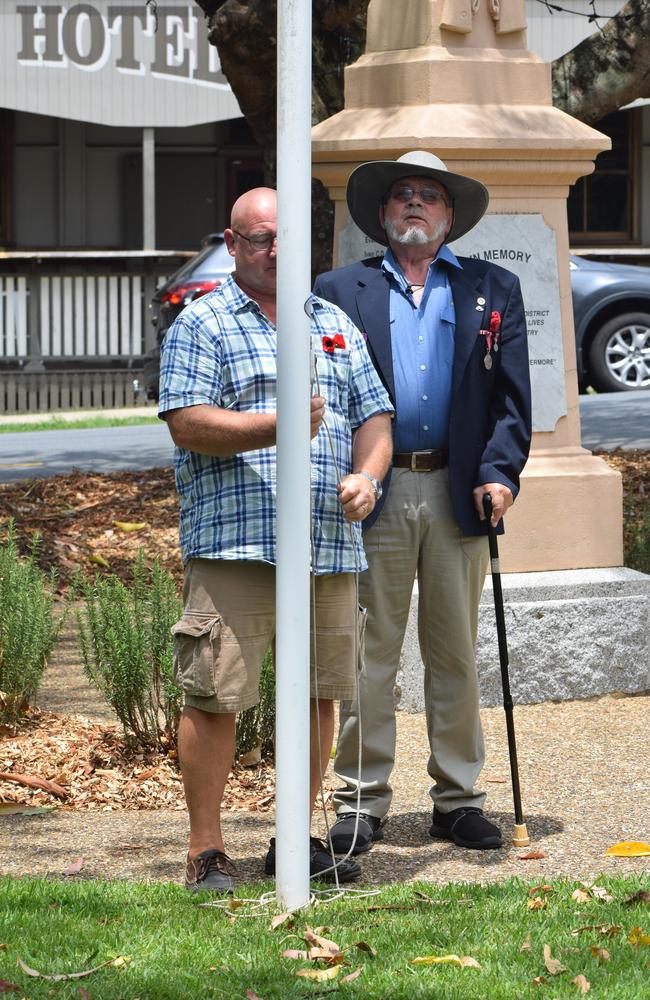 A pair working together to raise the flag at Yandina.