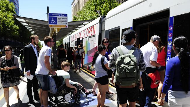 Dignity for Disability MLC Kelly Vincent catching a tram on King William St. Pic Mark Brake