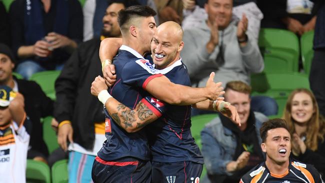 Rebels players Jack Maddocks (left) and Billy Meakes celebrate after Maddocks scored against the Brumbies on Friday night. Picture: AAP   