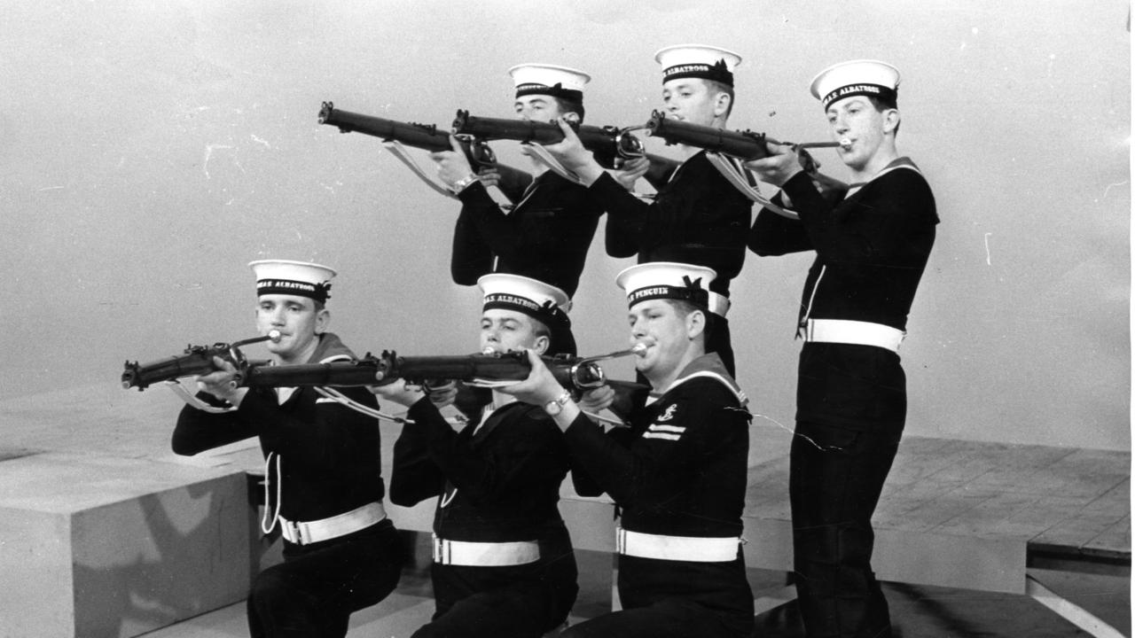 Royal Australian Navy band, 1965. Six members of the 70-strong RAN band in Adelaide for the Royal Show. Their .303 rifles became musical instruments by having mouthpieces inserted in the breeches, and a novel note was produced.