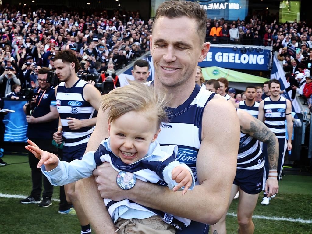 Geelong skipper Joel Selwood carries Levi Ablett onto the MCG before the 2022 AFL grand final. Picture: Michael Klein.