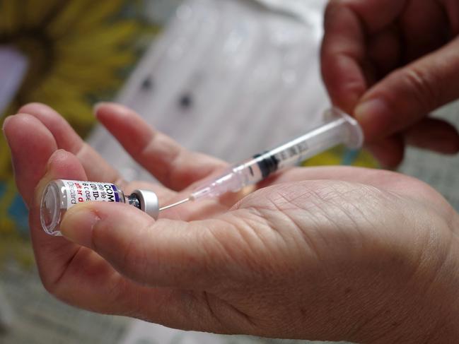 A health worker prepares a dose of Pfizer COVID-19 coronavirus vaccine at a health center in Jakarta on February 1, 2023. (Photo by BAY ISMOYO / AFP)