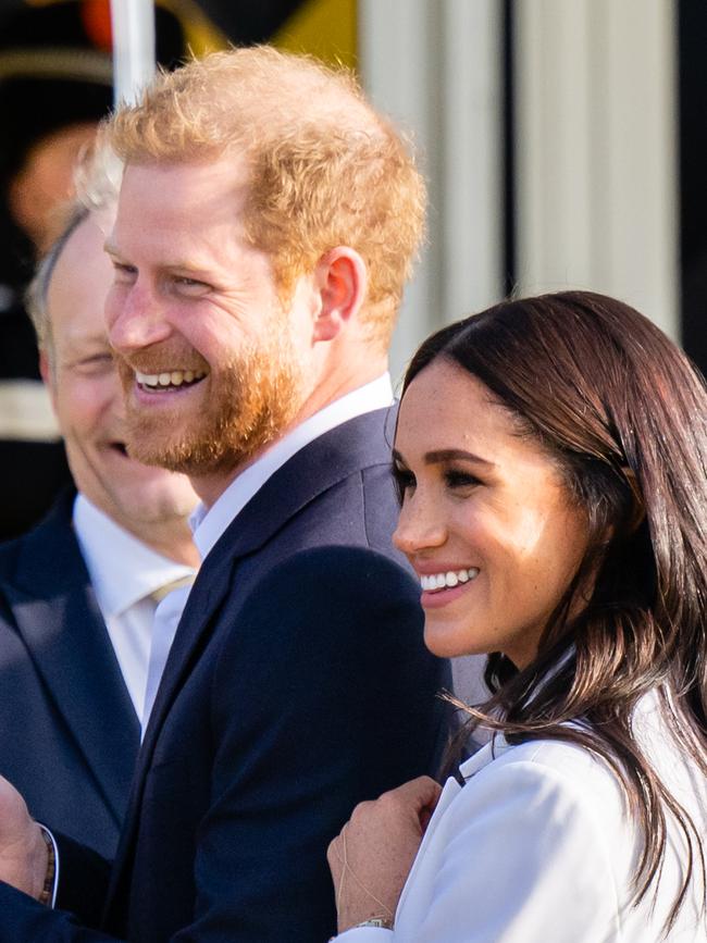 Prince Harry and Meghan speak with officials as they arrive ahead of The Invictus Games in The Hague. Picture: AFP