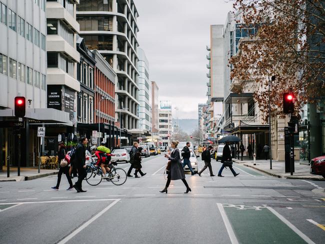 Morning commuters are seen walking across Pirie Street, in Adelaide, Wednesday, August 7, 2019. (AAP Image/ Morgan Sette)