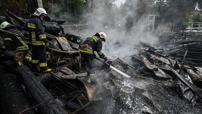 Firefighters douse the rubble of a restaurant complex destroyed by a missile strike in Kharkiv. Picture: AFP