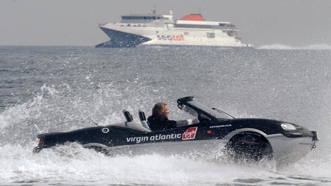 Branson, wearing a dinner jacket, drives his Aquada amphibian sports car across English Channel in 2004.