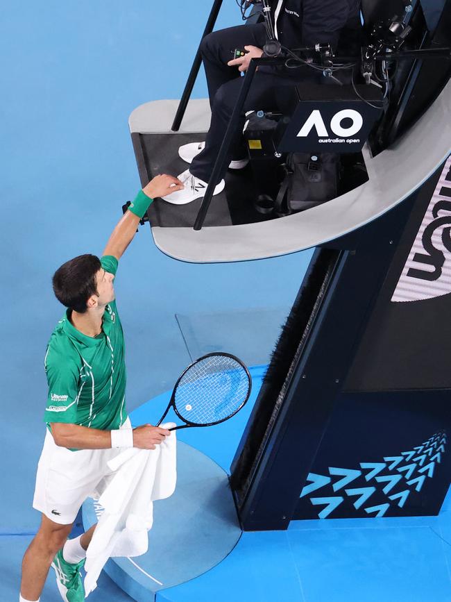 Novak Djokovic touches the umpire. Picture: David Gray/AFP