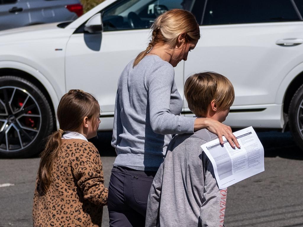 Schoolchildren are reunited with their parents. Picture: Seth Herald/Getty Images