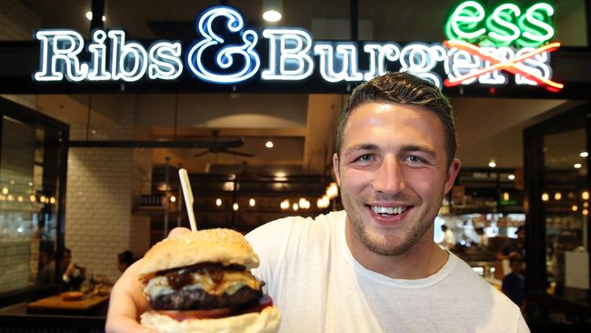 Big Sam with a ‘Burgess Burger’ at Ribs &amp; Burgers. Picture: Craig Greenhill