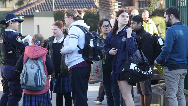 Concerned residents talk to officers today following the evacuation. Picture: John Grainger