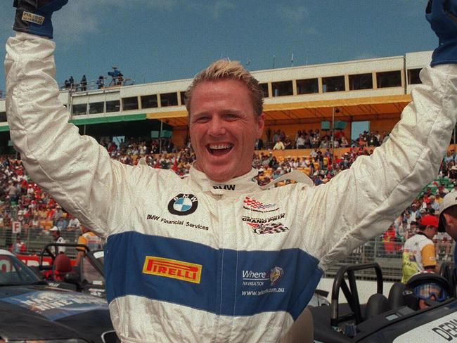 Former AFL player & TV personality Dermott Brereton raises arms in victory 07/03/99 after winning celebrity race at Albert Park prior to 1999 Australian Formula One (F1) Grand Prix.Australian Rules P/