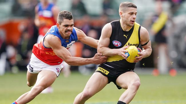 Charlie Cameron tries to stop Richmond’s Dion Prestia. Picture: AAP