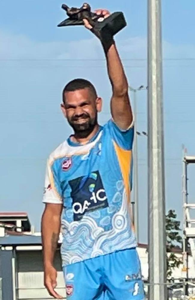 Victorious Purga Wagtails captain Wes Conlon raises the trophy after his team won the 2021 Queensland Murri Carnival.