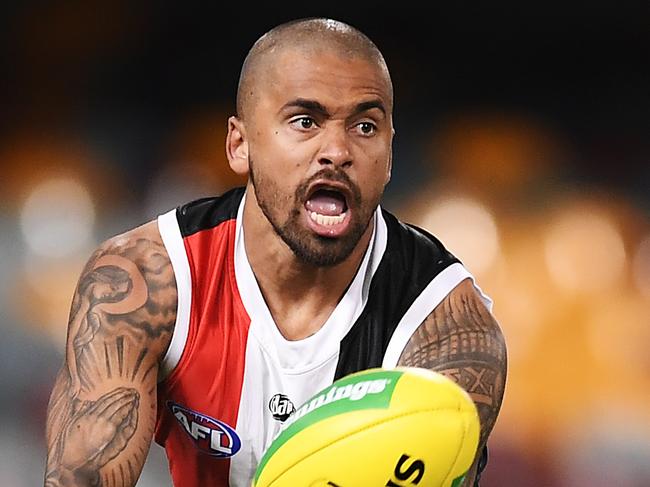 BRISBANE, AUSTRALIA - AUGUST 10: Brad Hill of the Saints handballs during the round 11 AFL match between the St Kilda Saints and the Geelong Cats at The Gabba on August 10, 2020 in Brisbane, Australia. (Photo by Albert Perez/Getty Images)