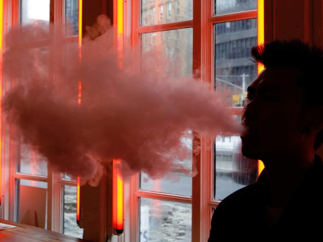 A customer exhales vapour from an e-cigarette at a store in New York. Picture: Frank Franklin II