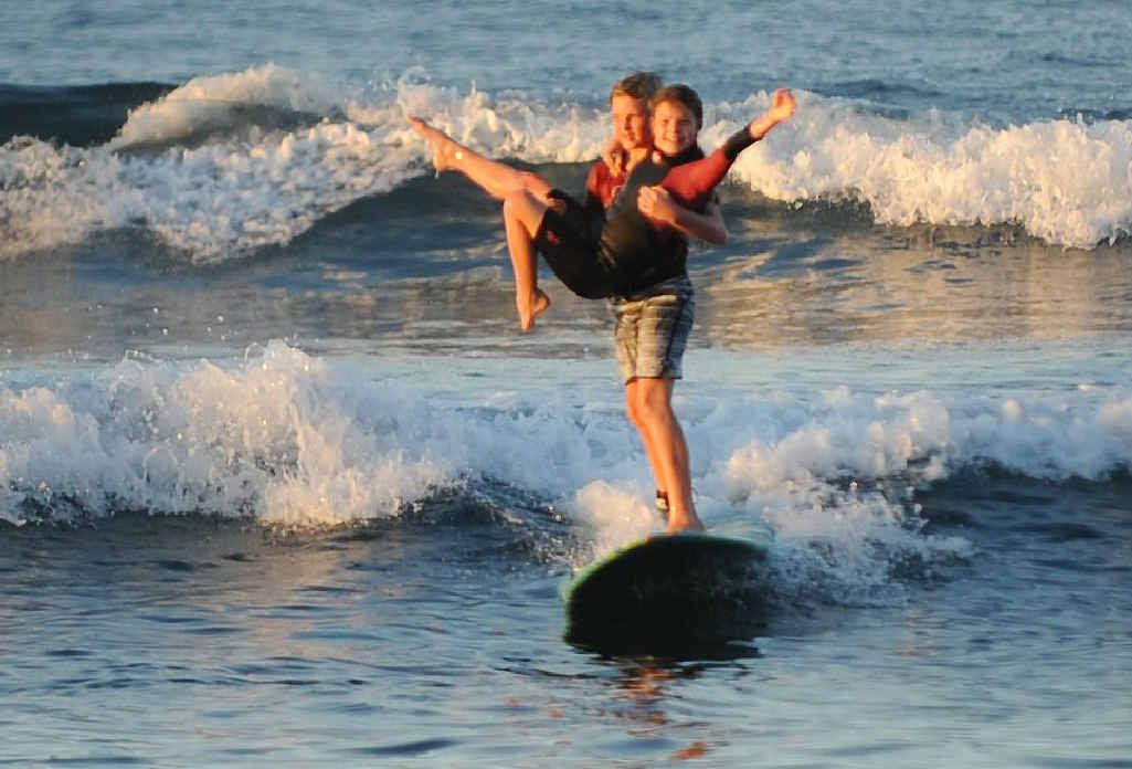 Young siblings master the tough art of tandem surfing | The Courier Mail