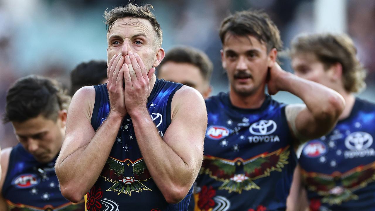 MELBOURNE, AUSTRALIA - MAY 18: Brodie Smith and his Crows team mates look dejected after losing the round 10 AFL match between Collingwood Magpies and Kuwarna (the Adelaide Crows) at Melbourne Cricket Ground, on May 18, 2024, in Melbourne, Australia. (Photo by Quinn Rooney/Getty Images)