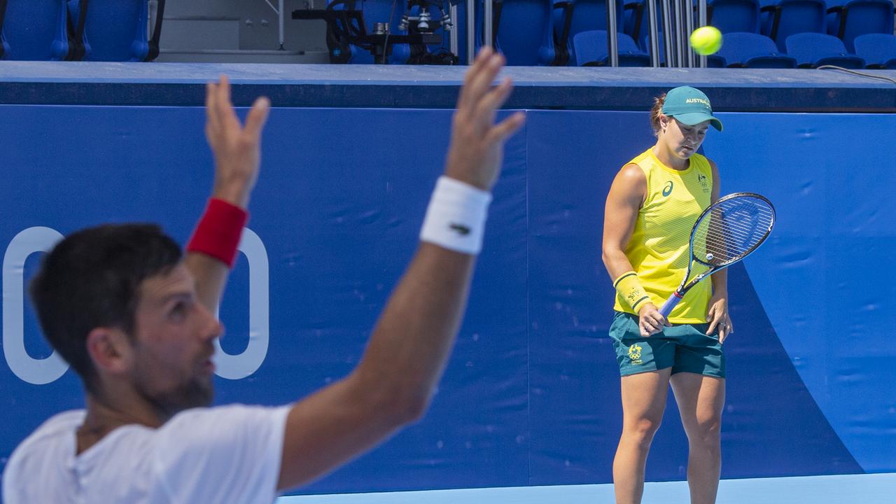 Novak Djokovic and Ash Barty had a friendly chat as they warmed up for the Olympics in Tokyo last week. (Photo by Tim Clayton/Corbis via Getty Images)