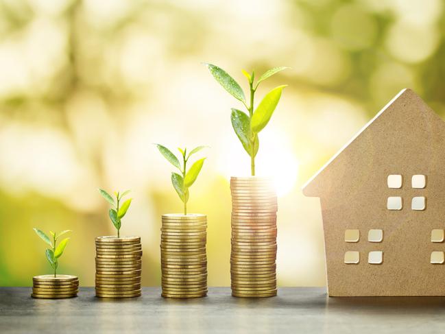 House Model and Golden Coins Stacks with blur Background.Savings Plans for Housing,Finance and Banking about House concept. property investing generic,